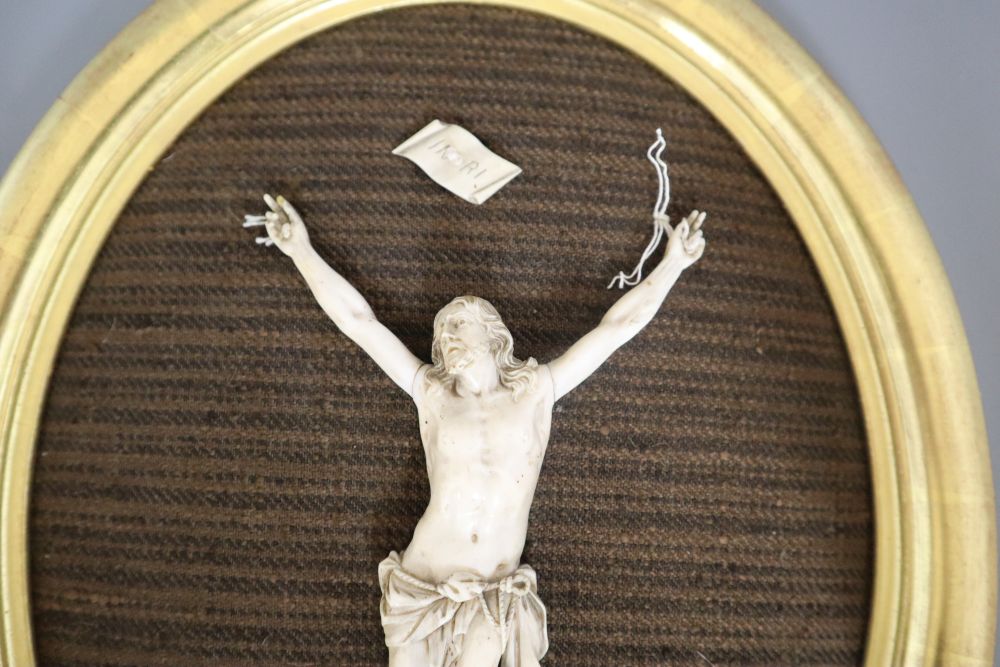 An ivory depiction of Christ, in gilt oval frame, carving 18cm